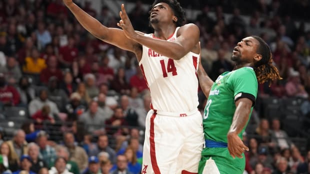Mar 16, 2023; Birmingham, AL, USA; Alabama Crimson Tide center Charles Bediako (14) shoots against Texas A&M-CC Islanders forward De'Lazarus Keys (13) during the first half in the first round of the 2023 NCAA Tournament at Legacy Arena. Mandatory Credit: Marvin Gentry-USA TODAY Sports